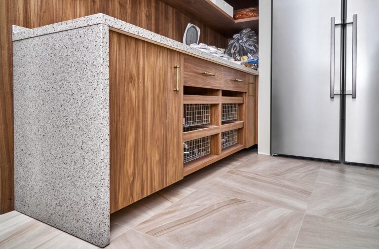wooden-cabinet-with-drawer-baskets-acrylic-solid-surface-countertop-light-food-storage-room-scaled